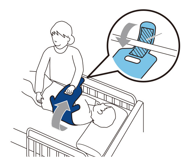 １．腕を胸の前で組ませ、ペンギンサポートを横に広げ、頭部から背中へ差し込みます。下部にあるグリップをひいて肩甲骨までずらします。